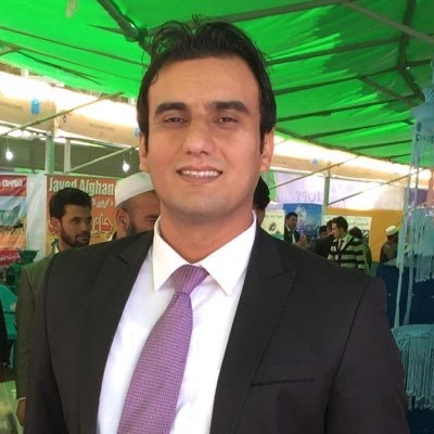 Fahim Safi smiles at the camera while wearing a suit and tie.