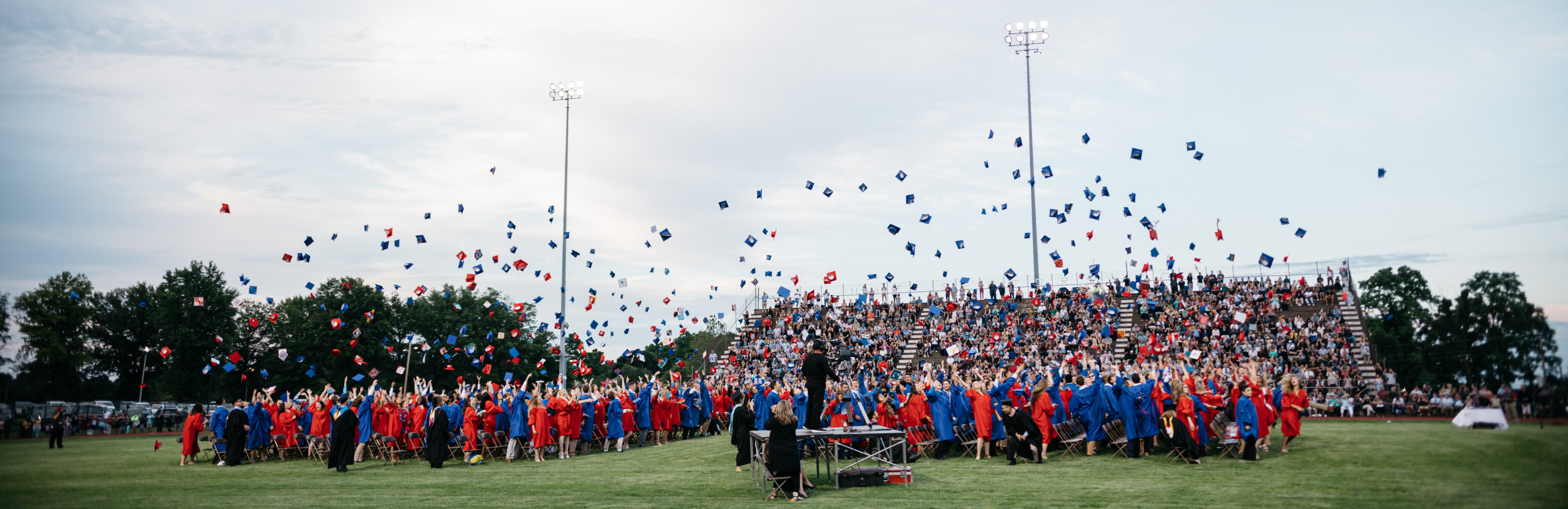 A high school graduation celebration in a football field.