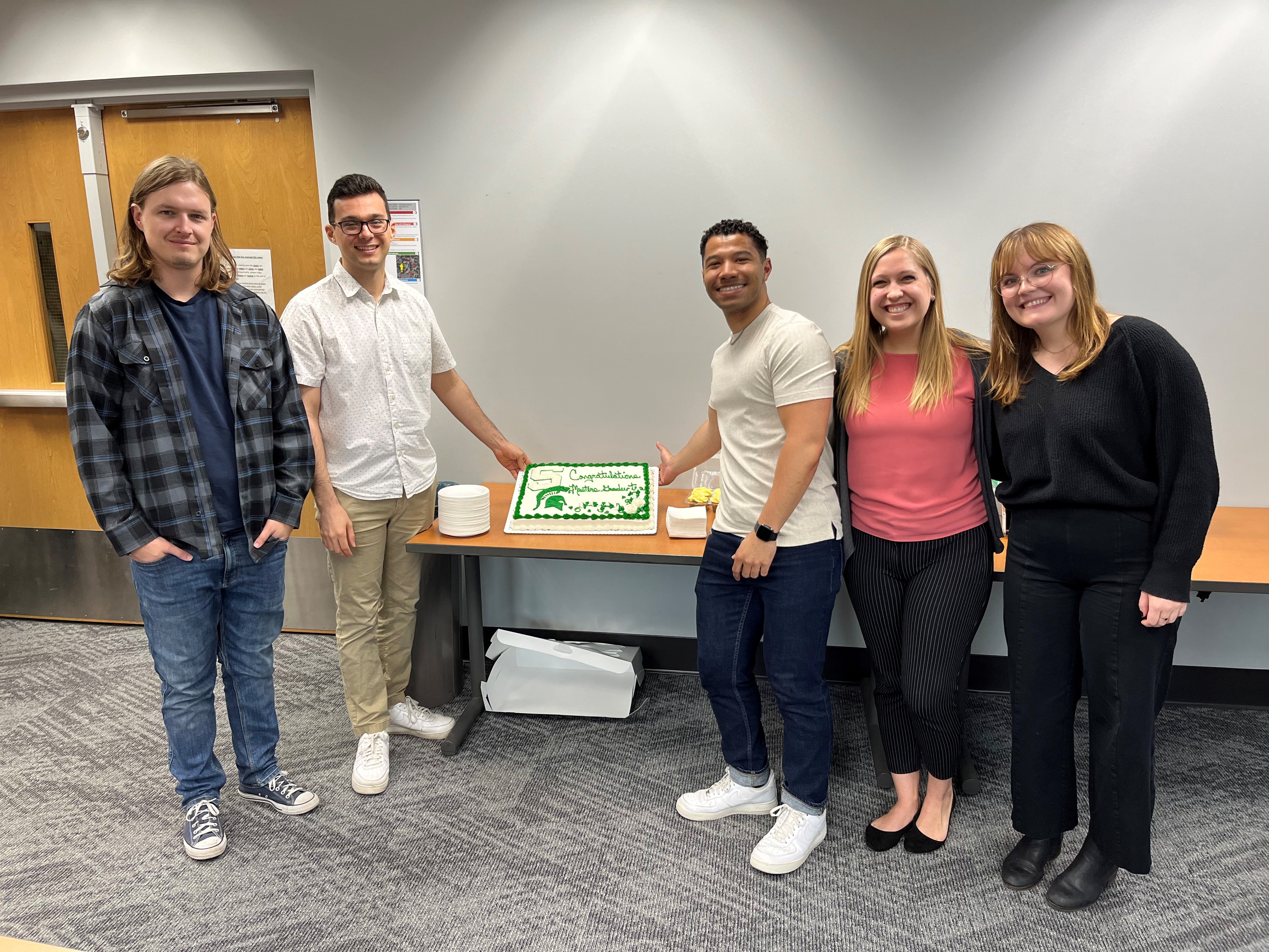 The Clinical Science master students smile with a congratulations cake!