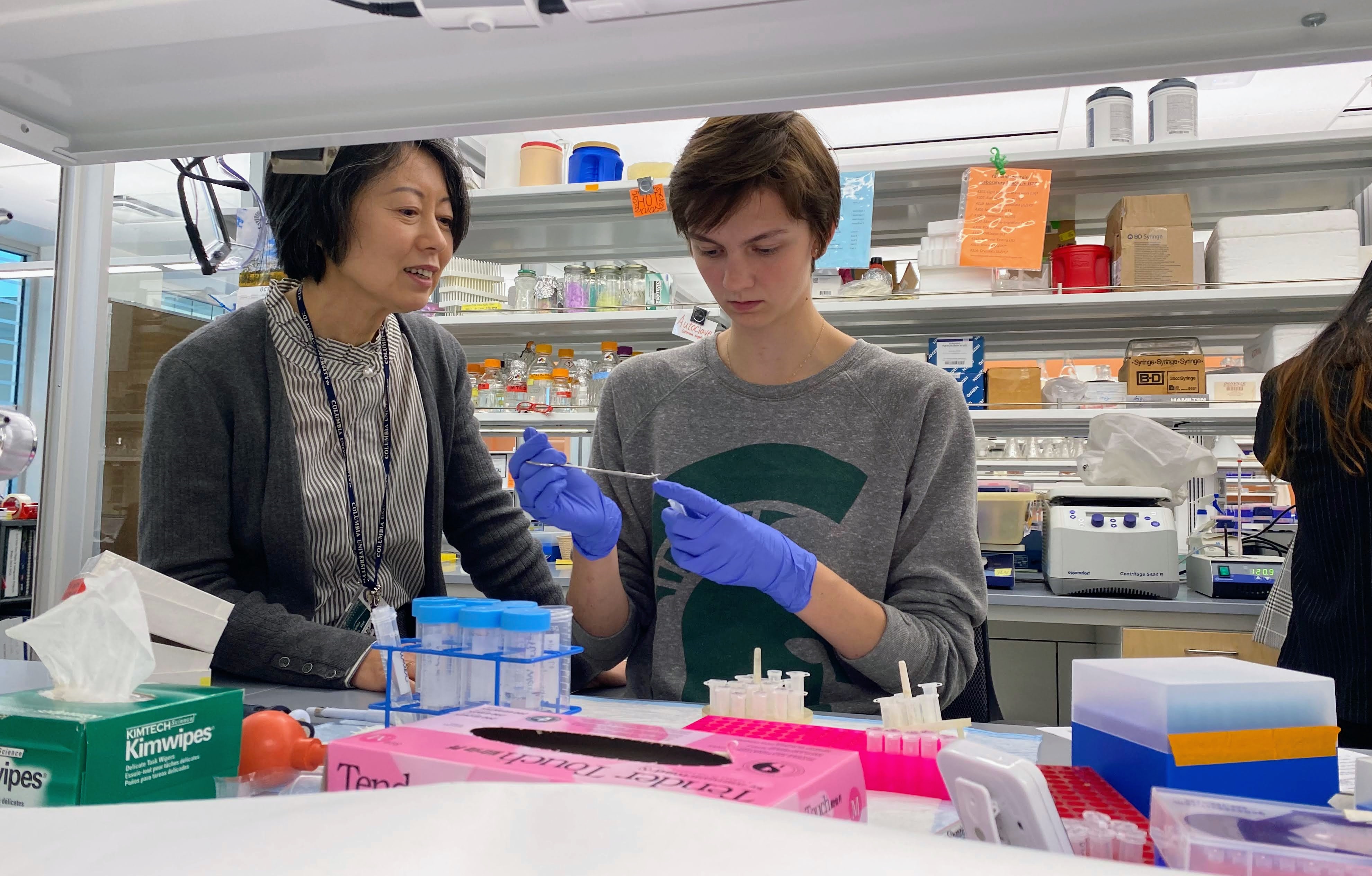 Dr. Yan and student work together in a lab.