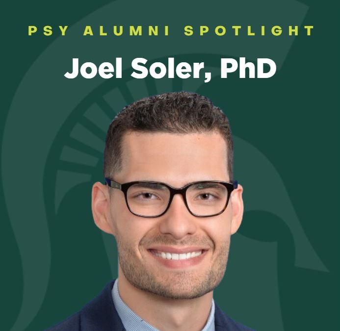 A green graphic with a faded Spartan head in the background. In the foreground, Joel Soler smiles at the camera while wearing a suit and glasses. At the top of the graphic it says “PSY Alumni Spotlight: Joel Soler, PhD.”