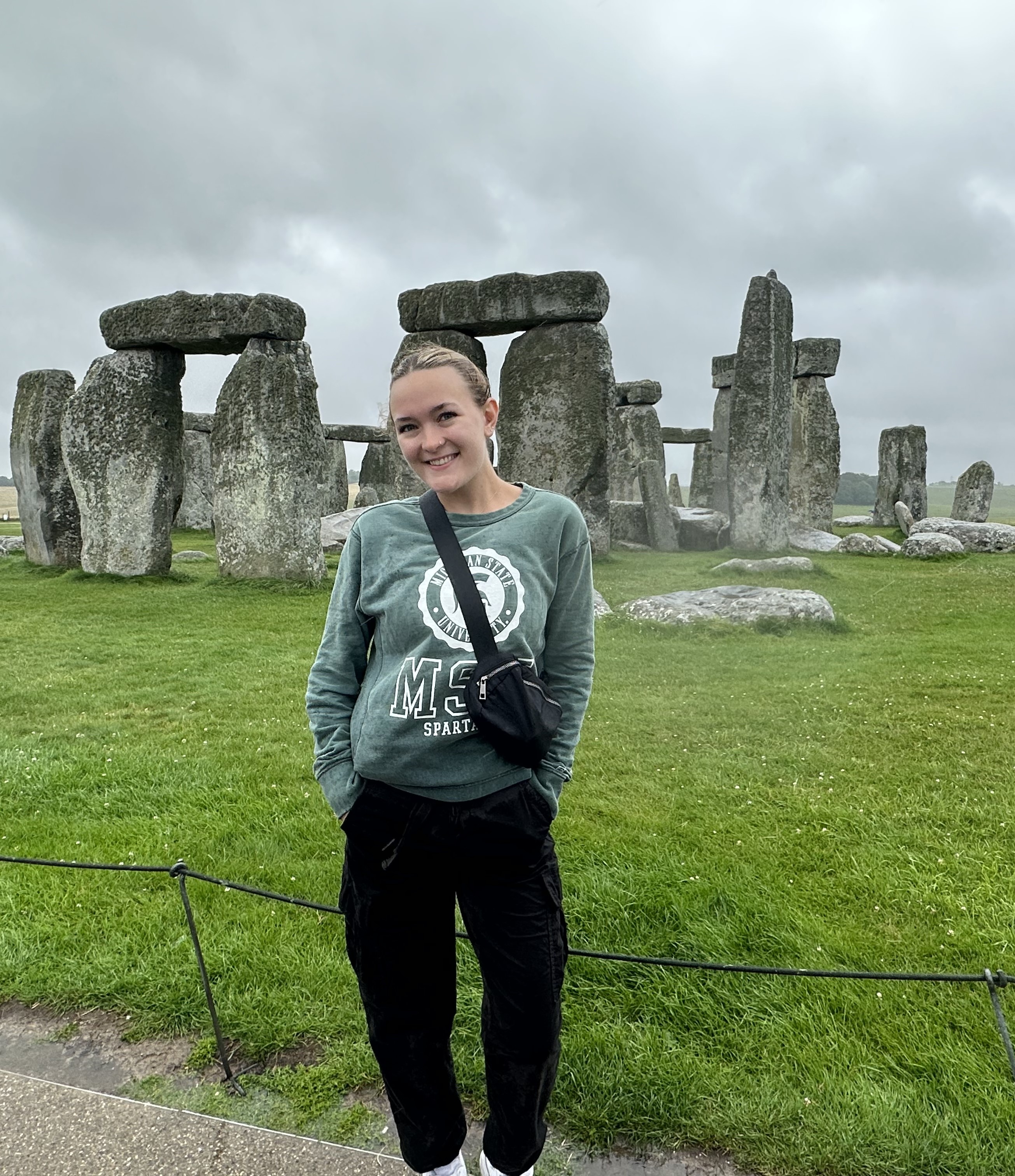 Kendra Kelly stands in front of Stonehenge