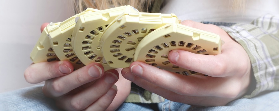 A woman's hands are shown holding birth control pills.