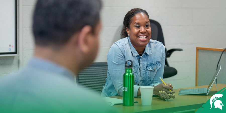 Dr. Roberson speaks at a table.