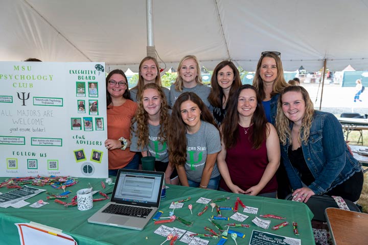 Th advising team pose together at a table.