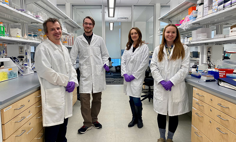 Dr. Alex Johnson, Nathan Pence, Dr. Jenna Lee, and Lauren Raycraft smile for the camera in the lab.